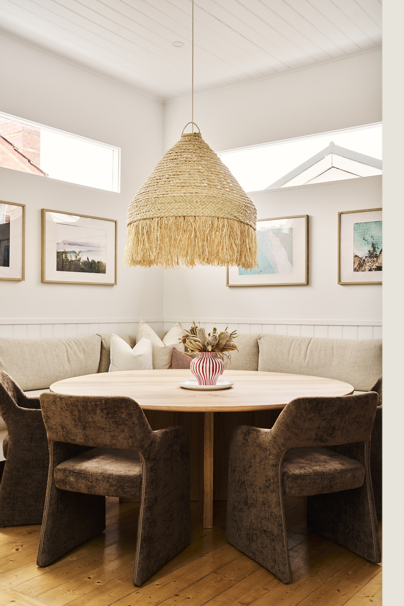 Breakfast nook with round timber table and woven pendant light